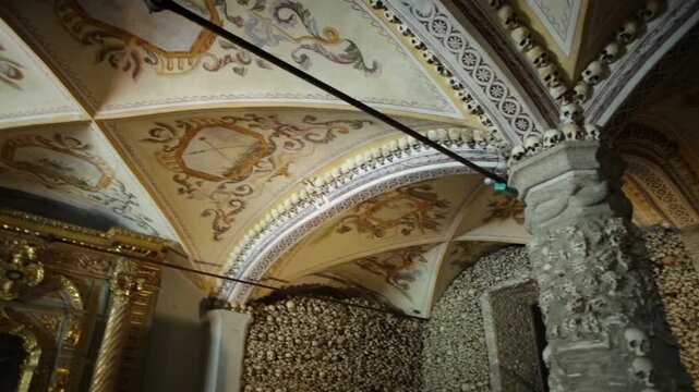 Evora, Portugal - August 18, 2017: Chapel of Bones, near Church of San Francesco, is one of most visited monuments of Evora, adorned with human bones and skulls. Mortuary-themed painted ceiling.