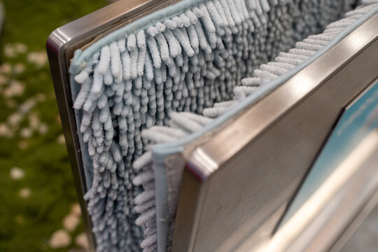 Close up of microfiber mop head hanging on metal rack for cleaning use
