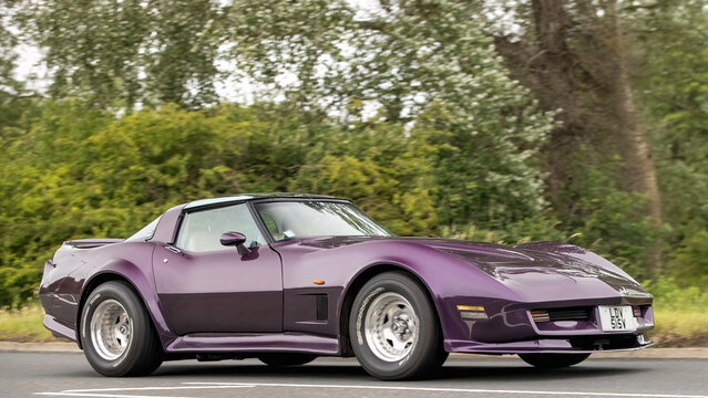 Stony Stratford,Bucks,UK - June 7th 2026:  1979 purple Chevrolet Corvette classic American car driving on a British road
