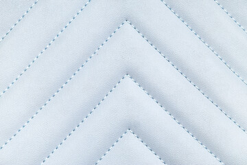 Naklejka premium Light blue quilted leather texture with chevron stitching pattern, luxury upholstery and fashion material background
