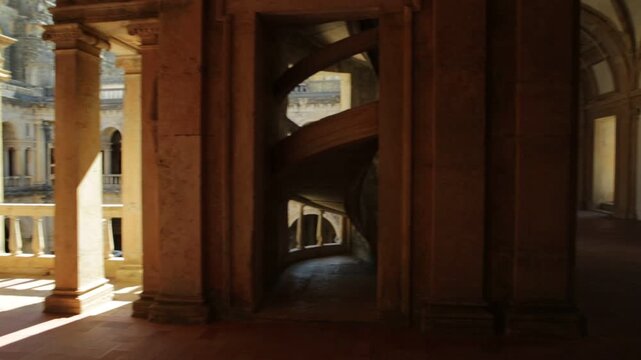 Tomar, Portugal - August 10, 2017: perspective view pov of the double porch inside Claustro da Hospedaria or Guests in Templar Castle of Tomar or Convent of Christ. Unesco Heritage and popular place.