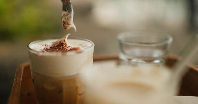 Indulge in a Delicious and Creamy Glass of Traditional Vietnamese Salted Coffee, Topped with a Rich, Frothy Foam and Cocoa Powder, Offering a Unique Blend of Sweet and Savory Flavors for a Delightful