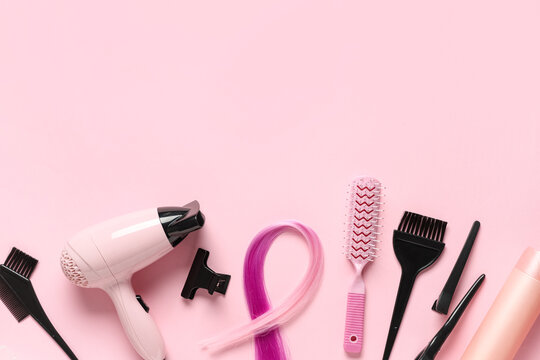 Hairdressing tools and pink hair extension on pastel background for salon and beauty concepts