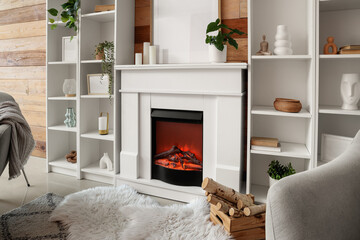 Obraz premium Modern living room interior with white fireplace, bookshelves, and cozy decor for home comfort and relaxation
