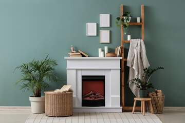 Obraz premium Cozy living room interior with white fireplace, green wall, houseplants, and decorative ladder