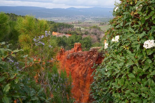 View of red and yellow ochre cliffs outside the town of Roussillon in Vaucluse, Provence, France