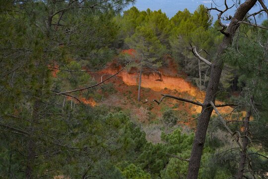 View of red and yellow ochre cliffs outside the town of Roussillon in Vaucluse, Provence, France