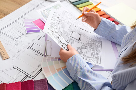 Architectural design process with blueprint landscape plan color swatches and fabric samples for interior and exterior project planning