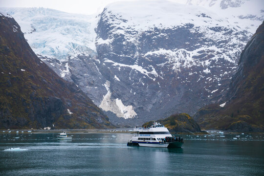 large tourist boat and small boat in bay at Kenai Fjords National Park