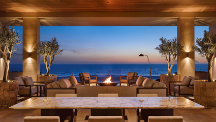 Obraz premium Luxury Beachfront Patio with Fire Pit and Ocean Sunset View