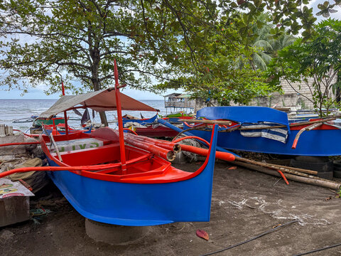 Colorful banca outrigger boats moored on a beach in Dumaguete