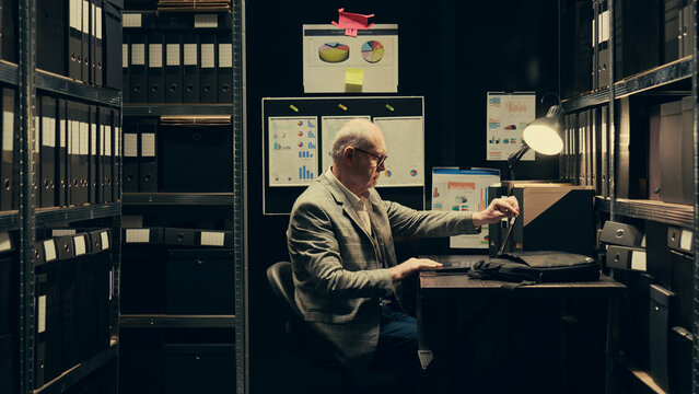 Senior investigator studying archive folders for case similarities, looking for incriminating evidence during legal inquiry. Law enforcement agent reading federal classified notes. Camera B.