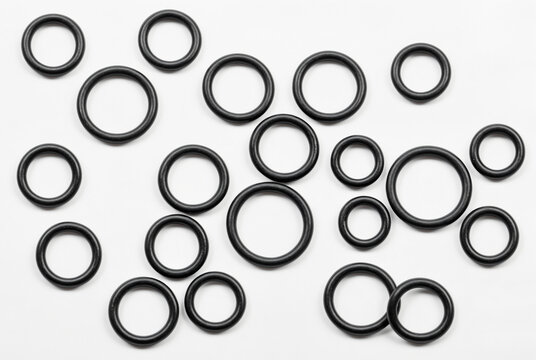 Collection of various black rubber O-rings and sealing gaskets isolated on white background