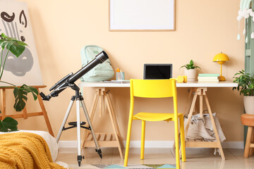 Modern student room interior with telescope, laptop, and yellow chair for learning and exploration © Pixel-Shot