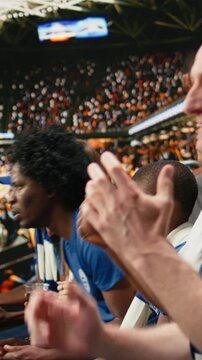 Vertical Video Disappointed soccer supporters reacting to missed chance during tense football match, filled with hope and tension in the stadium stands. Worried fans speechless and holding breath