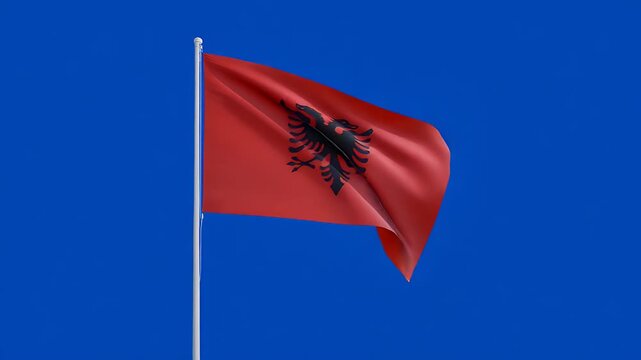 Albanian flag waving proudly against a brilliant blue sky background, showing national pride and identity in a dynamic, patriotic display