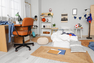 Fototapeta premium Interior of messy teenagers room with bed, workplace and shelf units