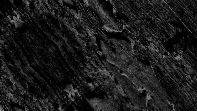 Rugged abstract texture with diagonal streaks, eroded surfaces, dark tones, and weathered appearance.