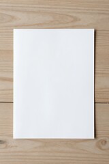 Naklejka premium Blank white paper on wooden table
