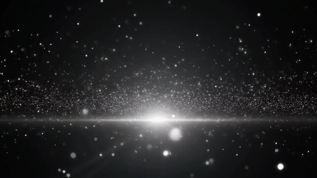 Abstract monochrome silver glitter particles floating over a bright horizon lens flare on dark background.