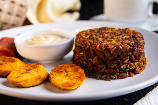 Close up of traditional Costa Rican gallo pinto breakfast with fried plantains and natilla