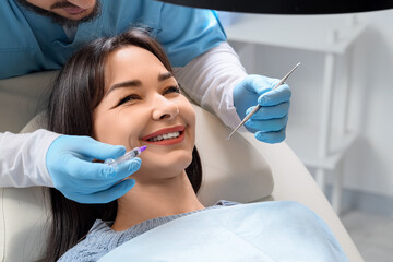 Fototapeta premium Young woman visiting dentist in clinic, closeup