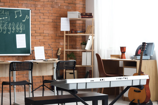 Music classroom interior with keyboard, guitar, and chalkboard for education and creative learning environment