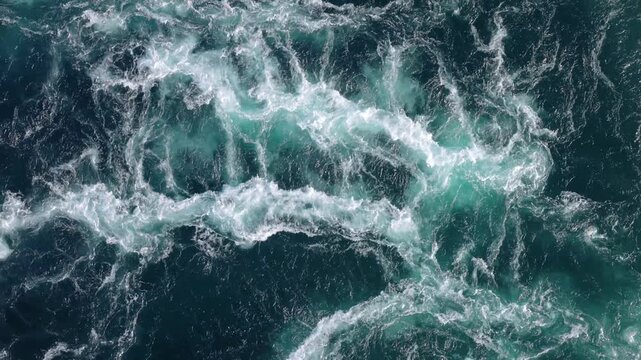 A top down view of a massive water current of the saltstraumen maelstrom in bod, norway, showing strong water movement.