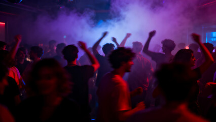Naklejka premium Group of friends celebrating with hands raised in vibrant nightclub with colorful lighting