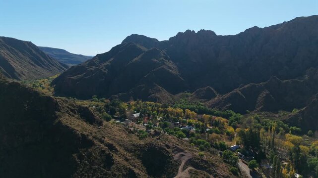 Mountain valley settlement along Ruta Provincial 173 in San Rafael Mendoza, aerial reveal tracking right in the morning