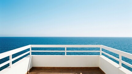Fototapeta premium Wide angle view of a minimalist balcony overlooking a calm blue ocean under a clear sky
