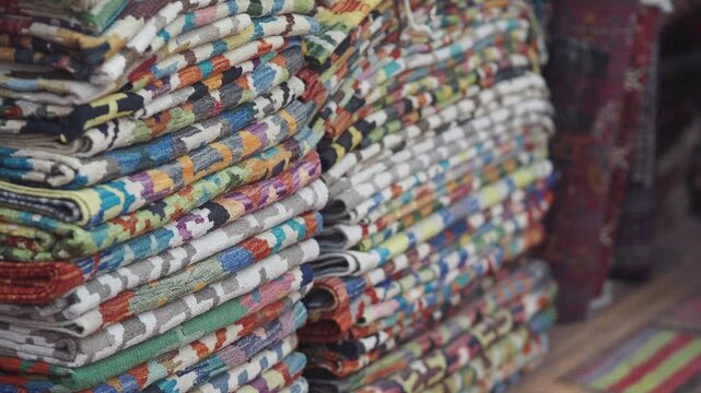 Colorful textiles stacked in a market in Marrakech
