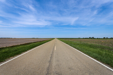 Fototapeta premium Empty Rural Highway Crossing Agricultural Land in Kansas