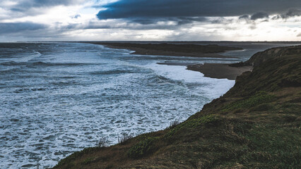 Fototapeta premium new zealand southland southern ocean stormy sea water dark waves crashing rocks cliffs nature wild 