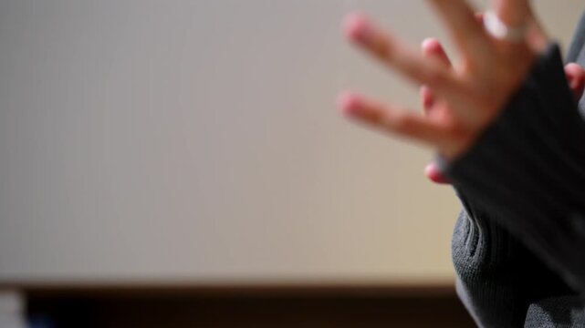 Close up of Person Hand Making Gesturing Sign with Copy Space in Workspace