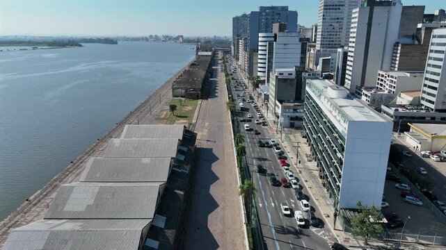 Mau&aacute; Avenue forward push along Porto Alegre waterfront with Gua&iacute;ba Lagoon and port warehouses