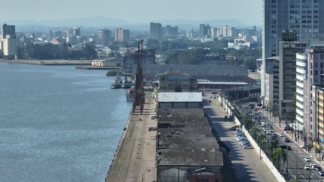 Dock port with gantry cranes along Mau&aacute; Avenue waterfront in Porto Alegre city center, truck right lateral movement
