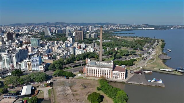 Orbit counterclockwise around the Usina do Gas&ocirc;metro chimney building at Lake Gua&iacute;ba waterfront in Porto Alegre, Brazil.