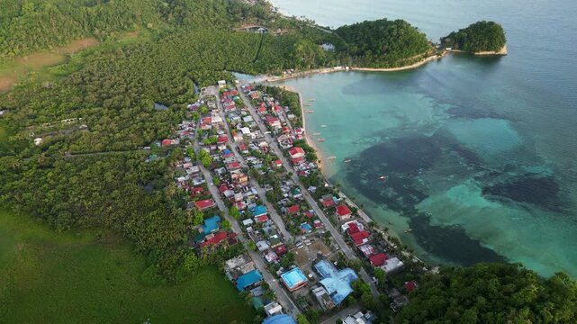 Coastal Barangay Of Magnesia Del Norte With Turquoise Clear Water In Virac, Catanduanes, Philippines. - aerial shot