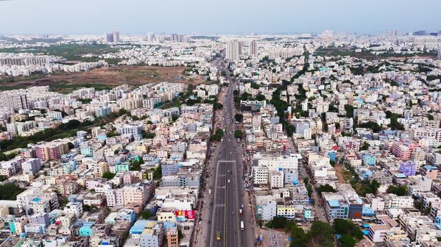 National highway 65 with residential buildings, Gangaram cheru, flyover, vehicles and Tower buildings at Gangaram, chanda nagar, hyderabad, telangana, india. day time, stable shot, drone shot, 4k.