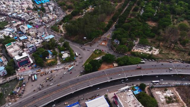 Bhel flyover With BHEL Entrance, flowing traffic, trees and buildings at Lingampally, Tara Nagar, Chanda Nagar, Hyderabad, Telangana, india. day time, semi orbit shot, drone shot, 4k.
