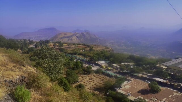 Scenic view from the Saptashrungi Gad funicular railway descending the hillside overlooking valleys mountains and settlements near Vani in Nashik Maharashtra India.