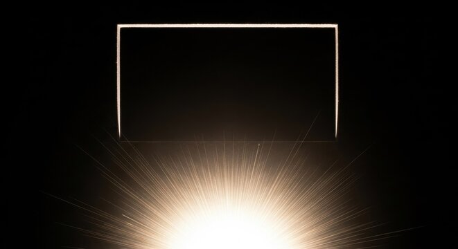 Bright radiant light burst at the bottom with sharp golden rays shining upwards towards a glowing white rectangular frame border isolated on a dark solid black background.