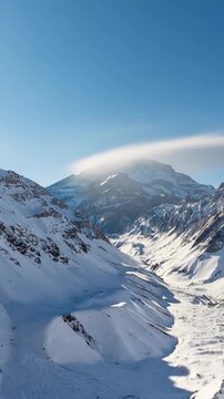 Aconcagua, a mountain in the Andes Mountains between Chile and Argentina. Aerial view in vertical video. Time lapse