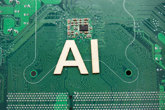 Close up of AI letters on computer motherboard.