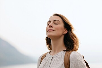 Fototapeta premium Woman enjoying fresh air outdoors feeling serene peaceful and relaxed breathing
