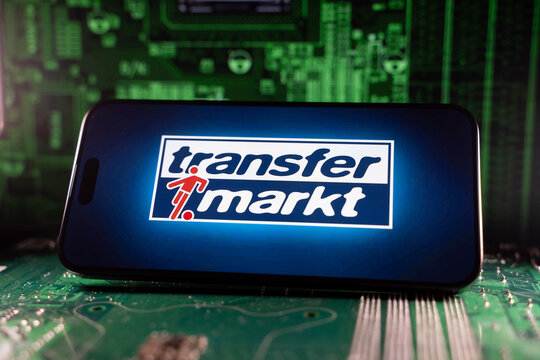 Close up of Transfermarkt logo on smartphone screen with motherboard background. Toronto, Canada - June 11, 2026.
