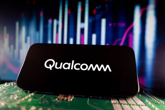Close up of Qualcomm logo on smartphone screen with financial chart background. Toronto, Canada - June 11, 2026.