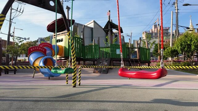 Two Empty Swings in Children Playground