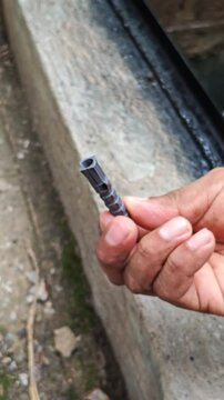 Close Up of a Person Showing a Grey Plastic Wall Anchor Plug